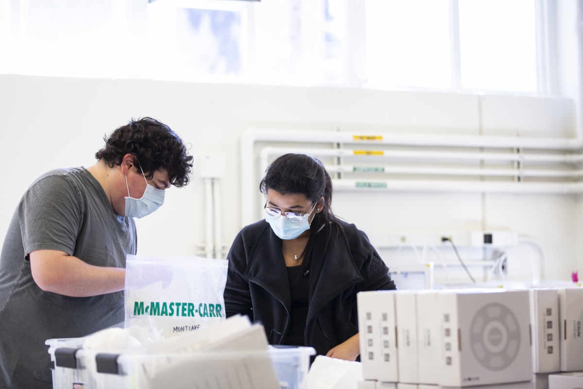 A man and a woman prepare a study of medical mask design