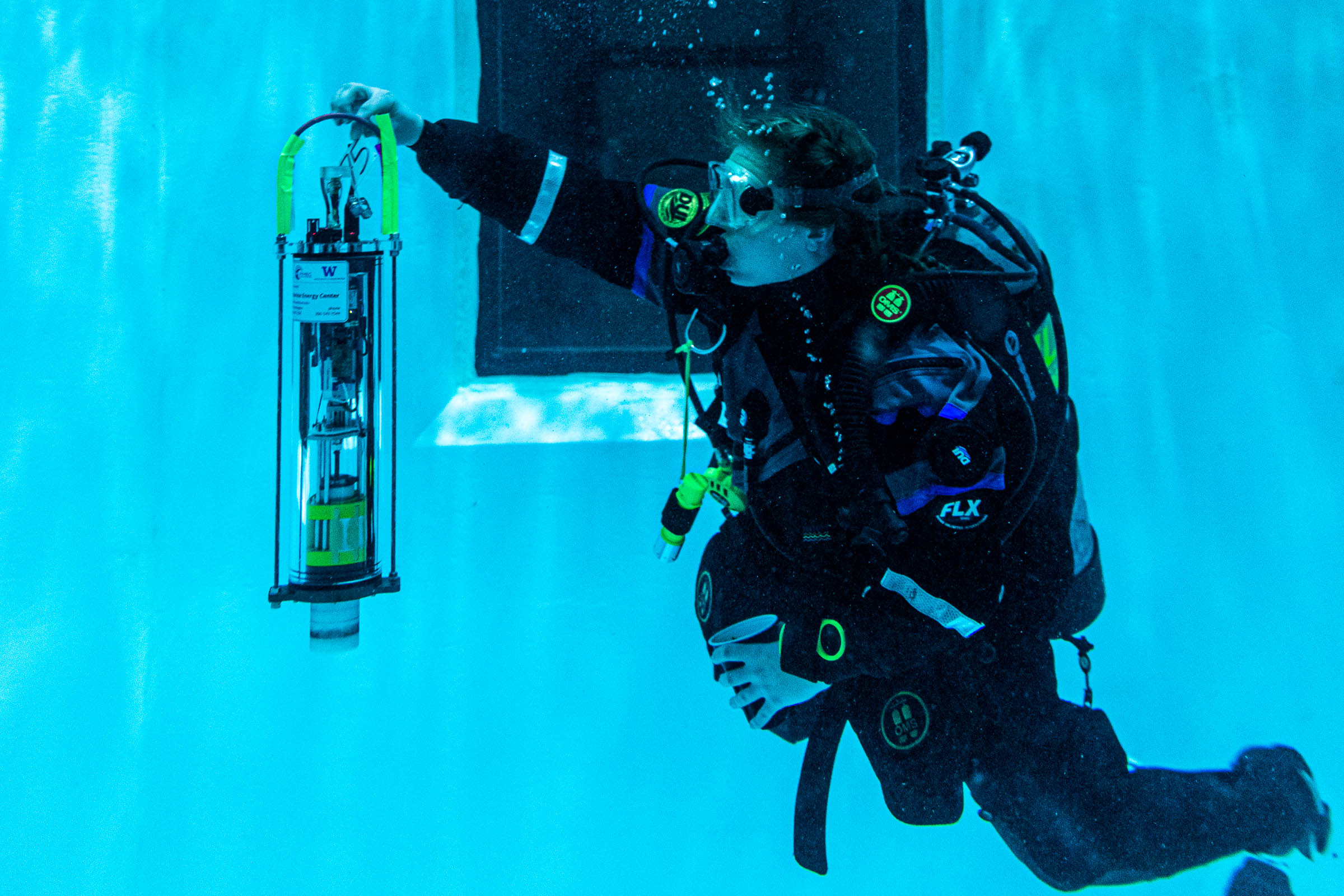 a diver holding a µFloat underwater