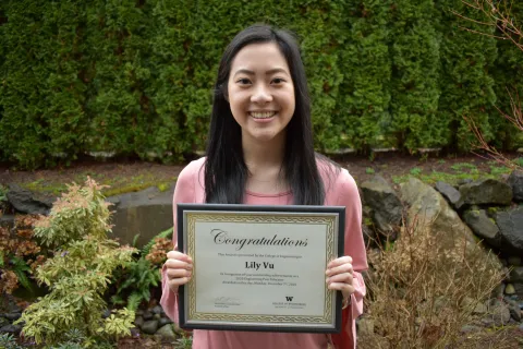 ME junior Lily Vu holding her 2020 Outstanding Engineering Peer Educator Award certificate