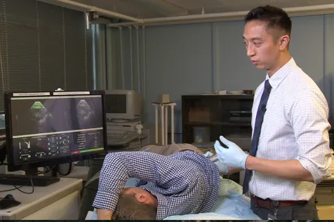 Researcher performing an ultrasound on a patient