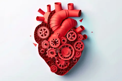 An artistic red heart made from gears and pipes against a light gray background
