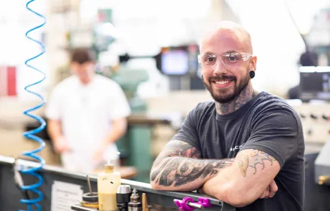 Raymond in machine shop wearing safety glasses