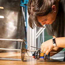 Person working on a mechanical device 